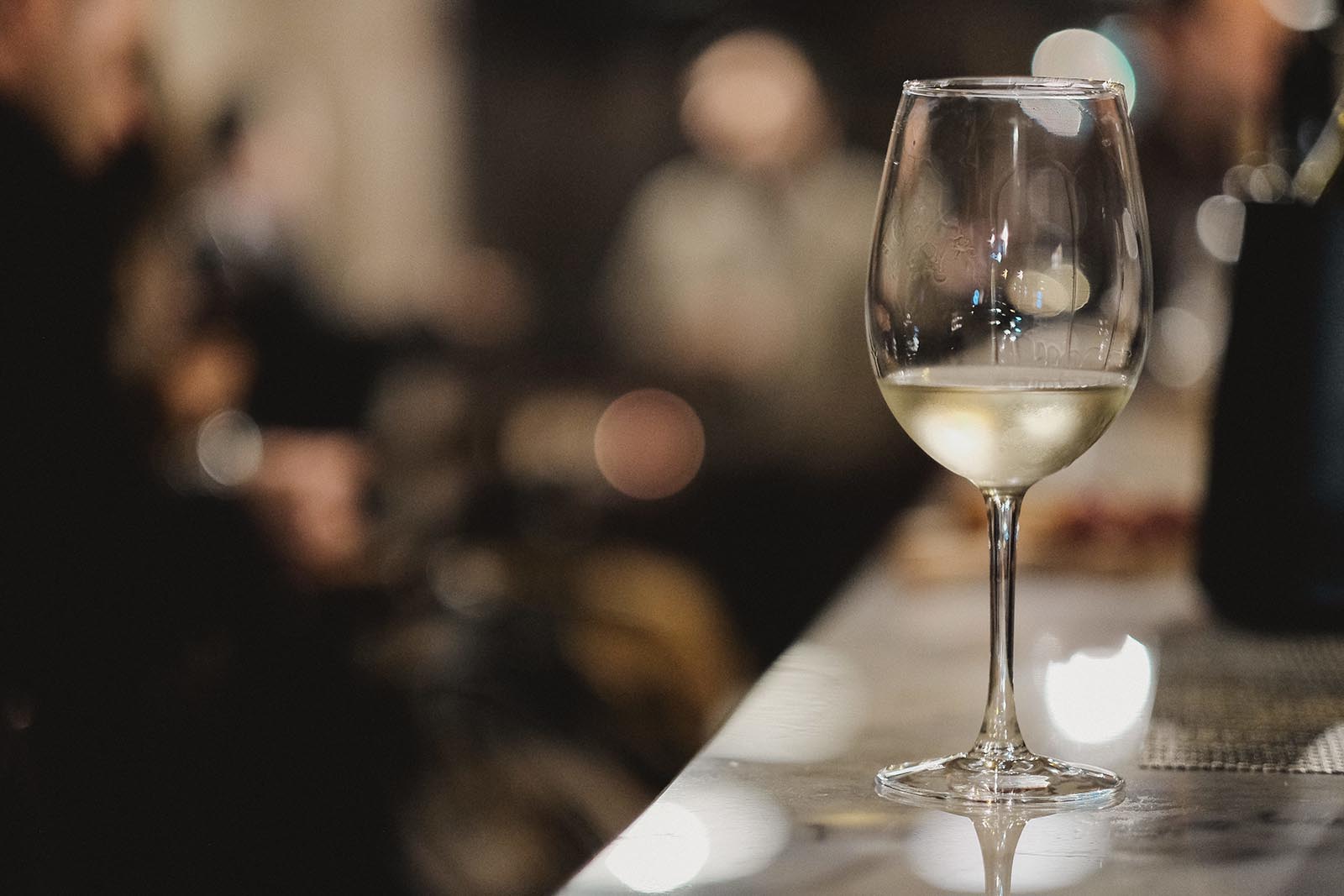 A shallow focus shot of a glass of white wine isolated
